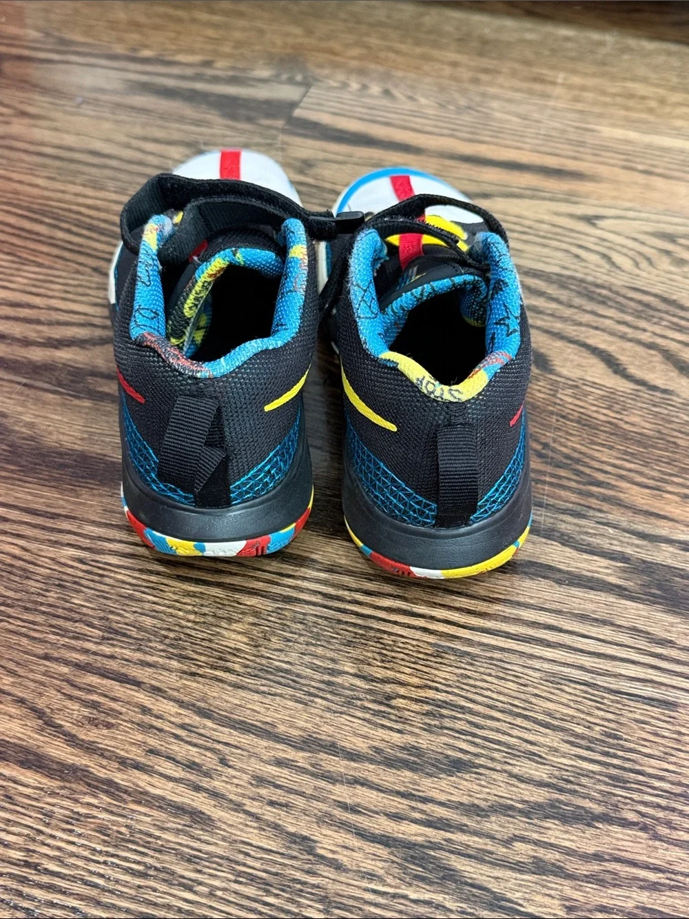 Nike Kids Black Sneakers with Blue, Red and Yellow Accents